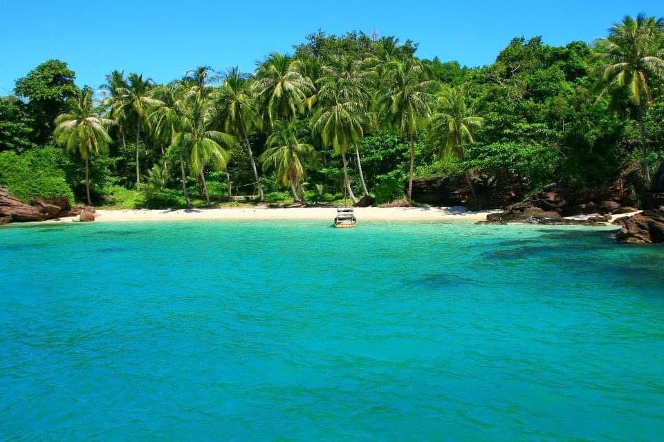Turquoise sea, a sandy beach and palm trees off the coast of Phu Quoc